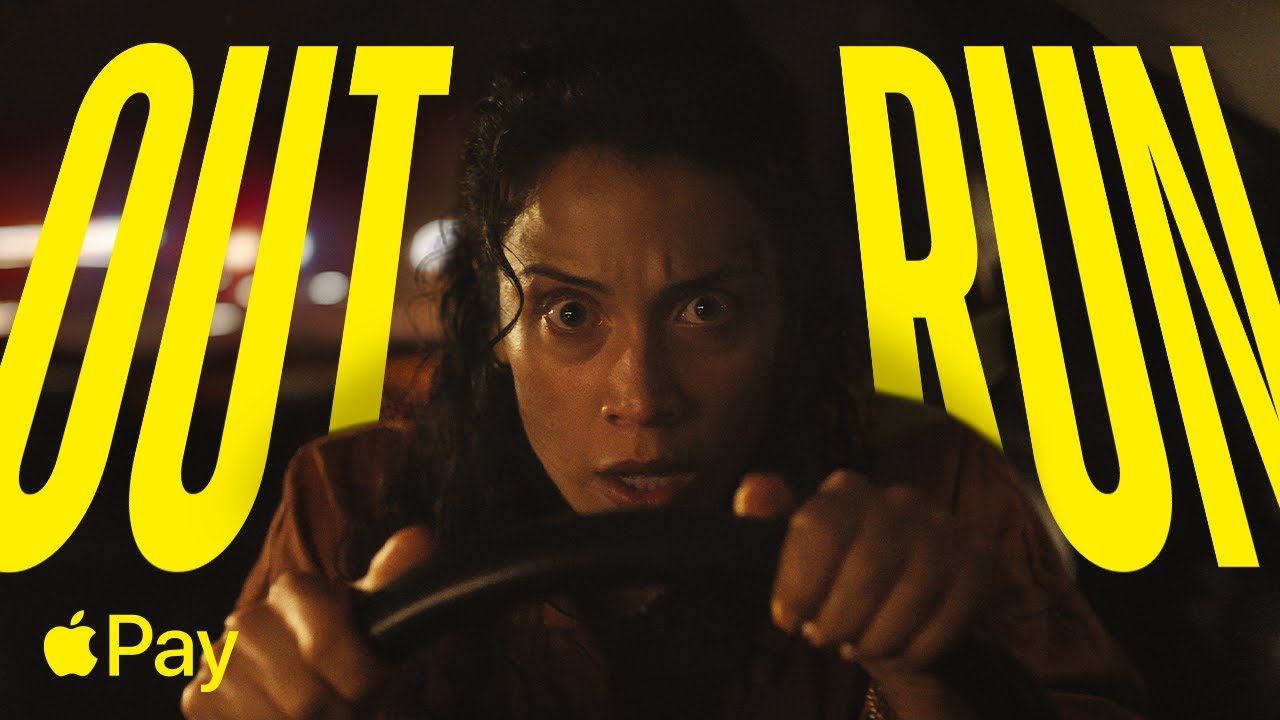 Woman at gas station using Apple Pay